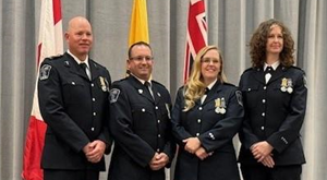 Four Paramedics stand together in formal uniform